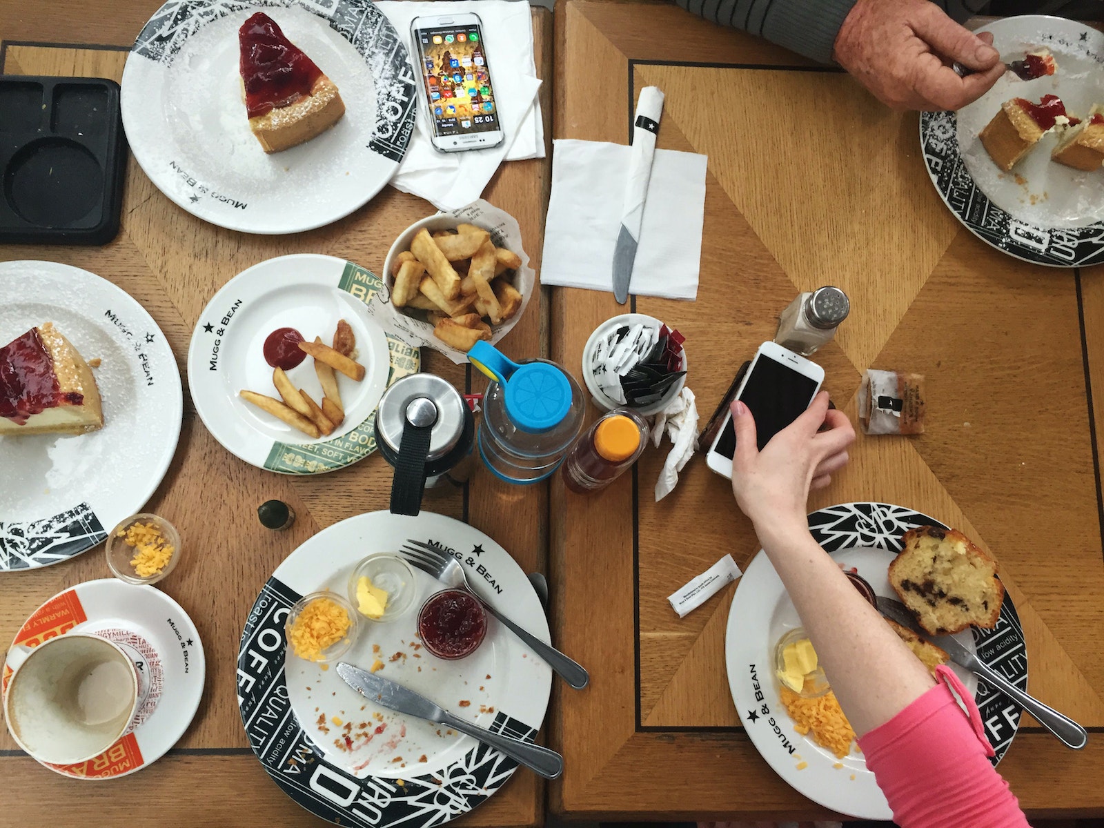 Person Holding Iphone on Table