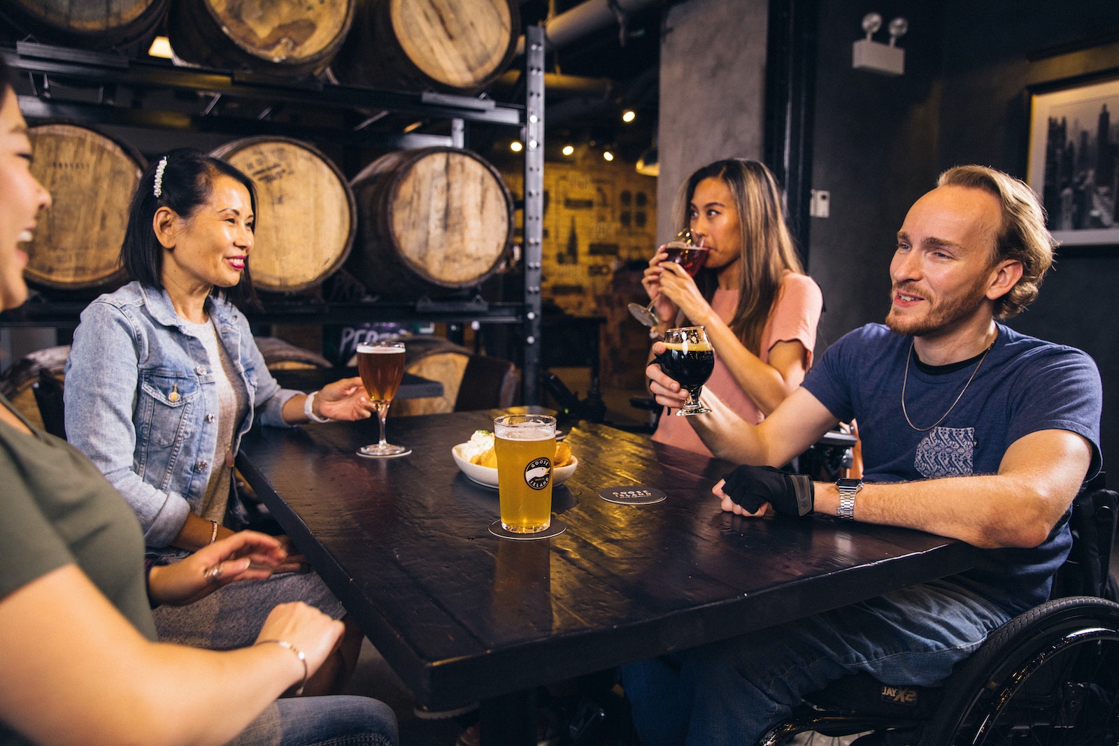 People Seated Around a Table and Drinking Beer